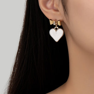 Two tone puffy heart and bow drop earrings